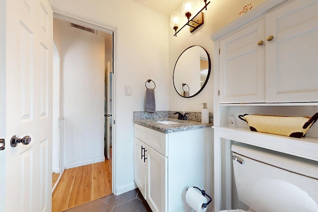 bathroom featuring tile patterned flooring, baseboards, vanity, and visible vents