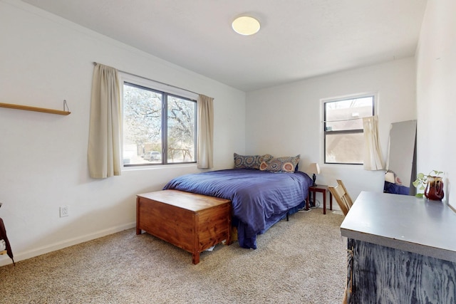 bedroom featuring baseboards and light colored carpet