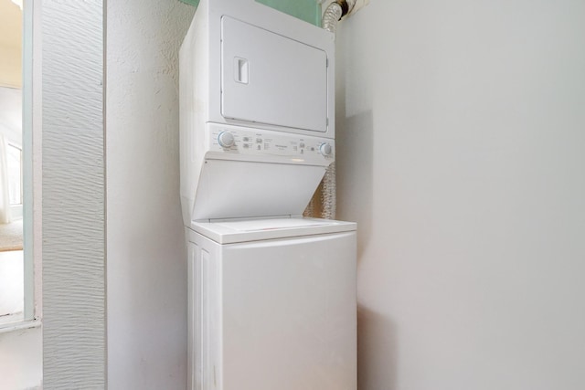 laundry area featuring laundry area and stacked washer and clothes dryer