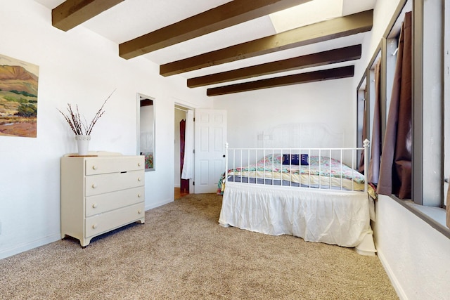 bedroom with beamed ceiling, baseboards, and carpet floors