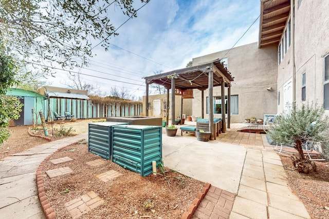 view of patio featuring an outdoor structure, fence, and an outdoor hangout area