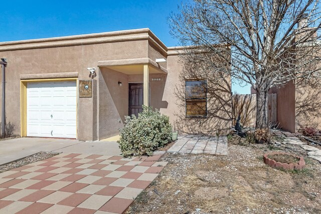 6817 Armand Rd NW, Albuquerque, NM 87120 - view of front facade with fence and stucco siding