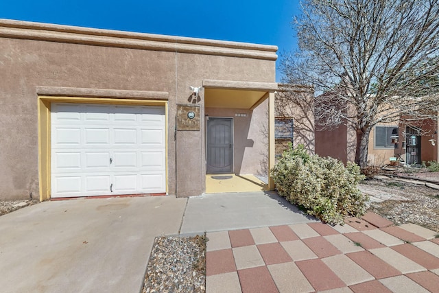6817 Armand Rd NW, Albuquerque, NM 87120 - view of front facade with stucco siding and a garage