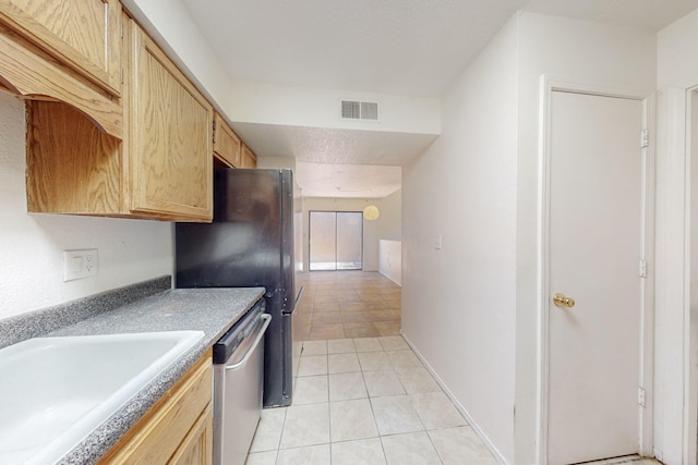 6817 Armand Rd NW, Albuquerque, NM 87120 - kitchen with light tile patterned floors, visible vents, freestanding refrigerator, a sink, and dishwasher