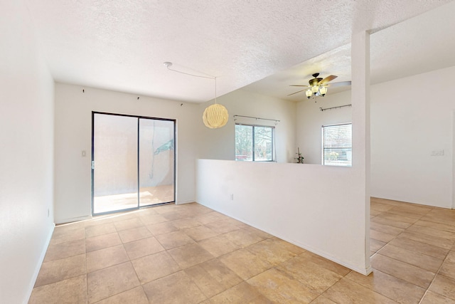 6817 Armand Rd NW, Albuquerque, NM 87120 - spare room featuring a textured ceiling and ceiling fan
