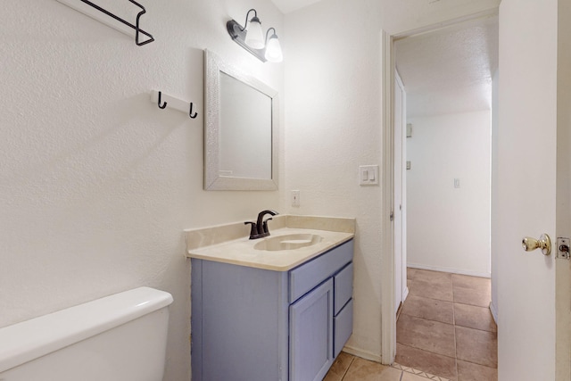 6817 Armand Rd NW, Albuquerque, NM 87120 - half bath featuring tile patterned floors, toilet, and vanity