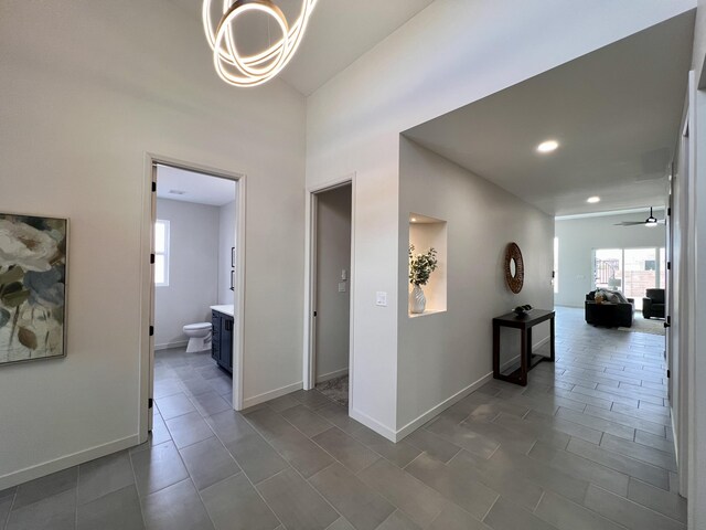 7908 Emerald Dr NW, Albuquerque, NM 87120 - hall featuring recessed lighting, baseboards, and a chandelier
