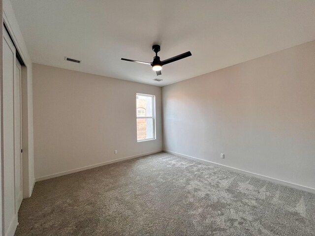7908 Emerald Dr NW, Albuquerque, NM 87120 - unfurnished bedroom featuring visible vents, baseboards, carpet, a closet, and a ceiling fan