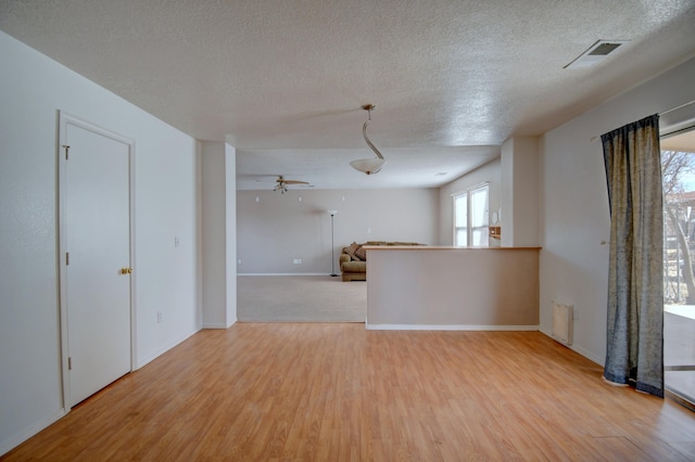 5750 Quay St, Rio Rancho, NM 87144 - spare room featuring visible vents, a textured ceiling, and wood finished floors