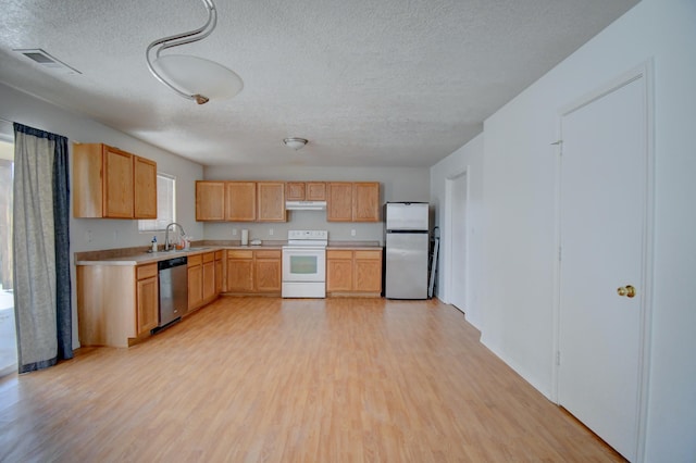 5750 Quay St, Rio Rancho, NM 87144 - kitchen with under cabinet range hood, light countertops, light wood-style flooring, stainless steel appliances, and a sink