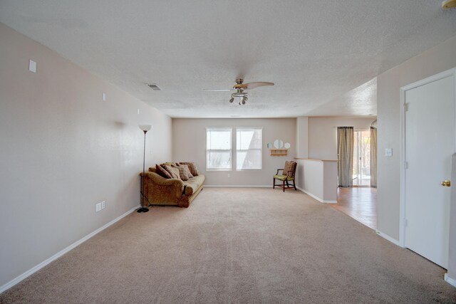 5750 Quay St, Rio Rancho, NM 87144 - unfurnished room with a ceiling fan, visible vents, baseboards, a textured ceiling, and light colored carpet