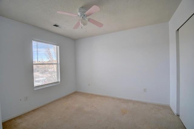 5750 Quay St, Rio Rancho, NM 87144 - unfurnished room featuring a ceiling fan, baseboards, visible vents, a textured ceiling, and light carpet