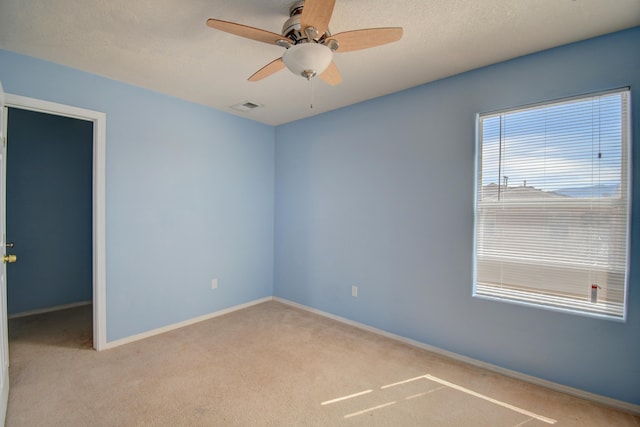 5750 Quay St, Rio Rancho, NM 87144 - empty room featuring visible vents, baseboards, ceiling fan, light carpet, and a textured ceiling