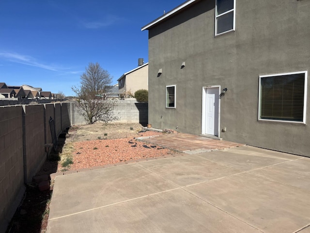 6204 Corte Alzira NW, Albuquerque, NM 87114 - back of property featuring a patio area, a fenced backyard, and stucco siding