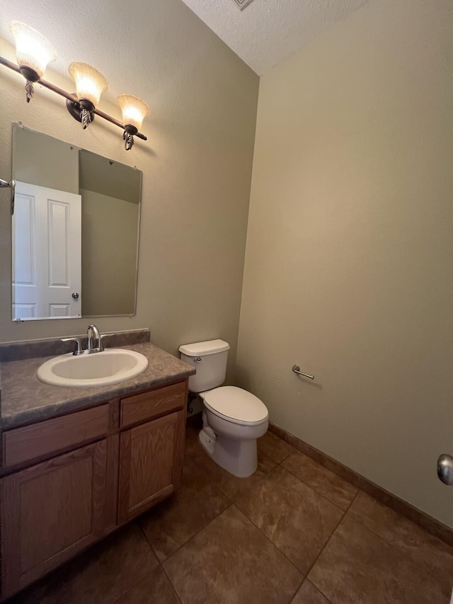 6204 Corte Alzira NW, Albuquerque, NM 87114 - bathroom with toilet, a textured ceiling, vanity, and tile patterned flooring