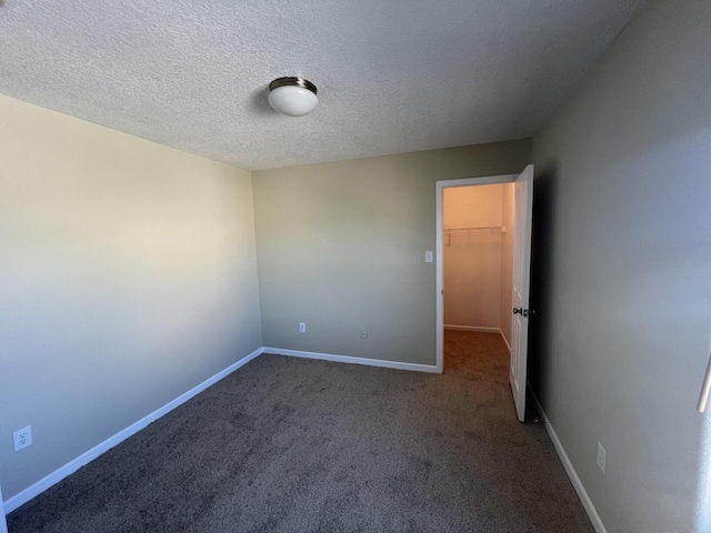 6204 Corte Alzira NW, Albuquerque, NM 87114 - spare room with carpet, a textured ceiling, and baseboards