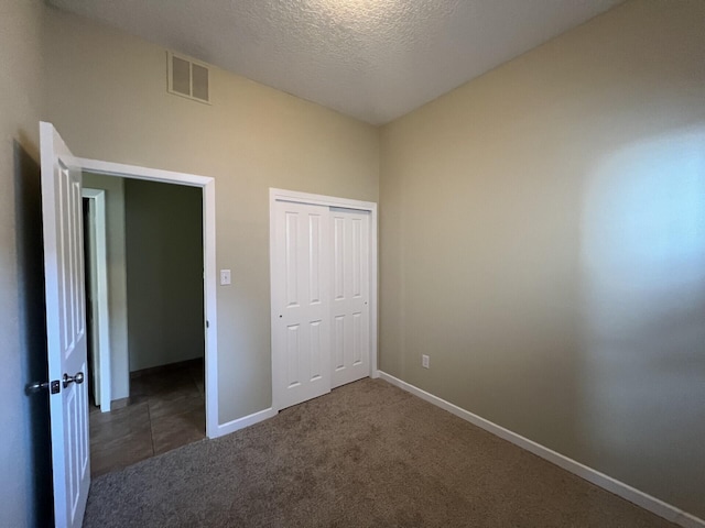 6204 Corte Alzira NW, Albuquerque, NM 87114 - unfurnished bedroom with a textured ceiling, a closet, baseboards, and visible vents