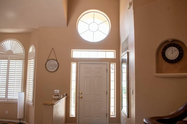 foyer with visible vents and a high ceiling