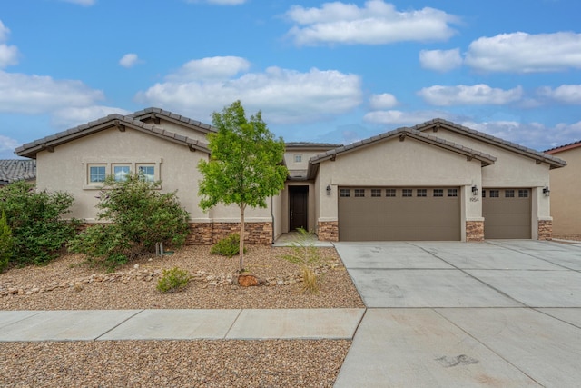 1954 Castle Peak Loop NE, Rio Rancho, NM 87144 - view of front of home featuring stone siding, a garage, and stucco siding