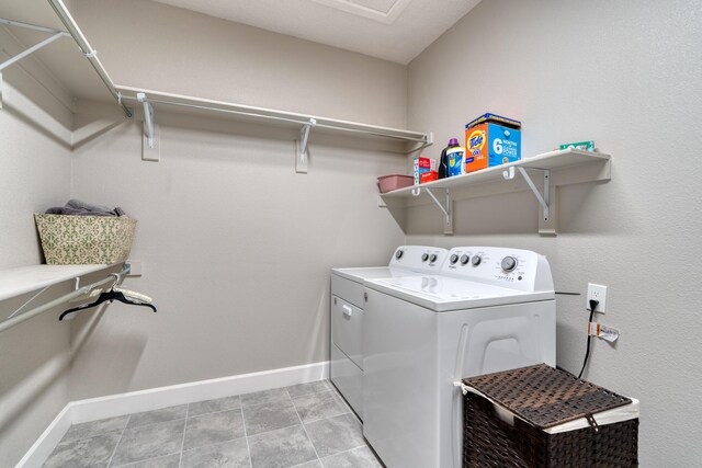 1954 Castle Peak Loop NE, Rio Rancho, NM 87144 - washroom with washer and clothes dryer and light tile patterned flooring