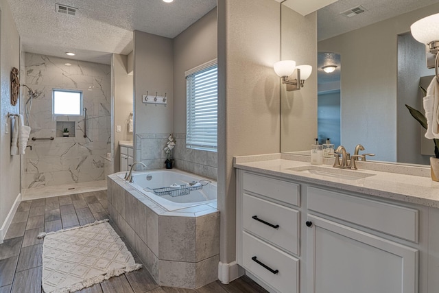 1954 Castle Peak Loop NE, Rio Rancho, NM 87144 - full bathroom with a textured ceiling, a garden tub, vanity, a marble finish shower, and healthy amount of natural light