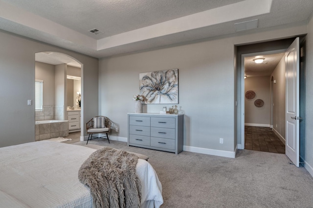 1954 Castle Peak Loop NE, Rio Rancho, NM 87144 - bedroom featuring arched walkways, carpet, a raised ceiling, a textured ceiling, and ensuite bath