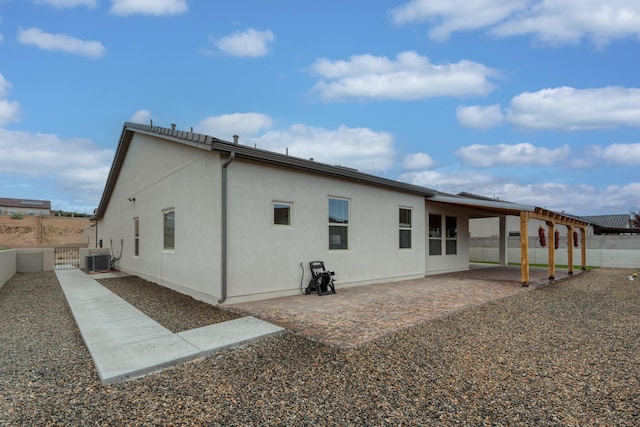 1954 Castle Peak Loop NE, Rio Rancho, NM 87144 - back of property with a fenced backyard, a patio area, and stucco siding