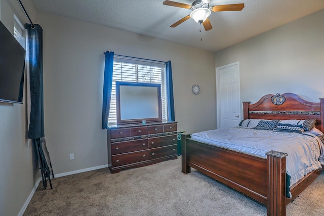 carpeted bedroom with baseboards and ceiling fan