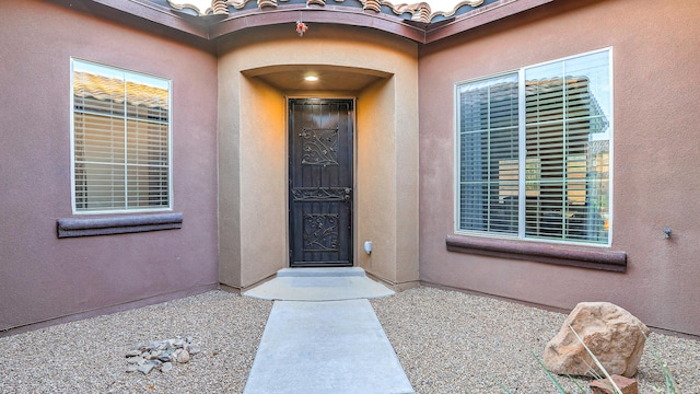 entrance to property with stucco siding