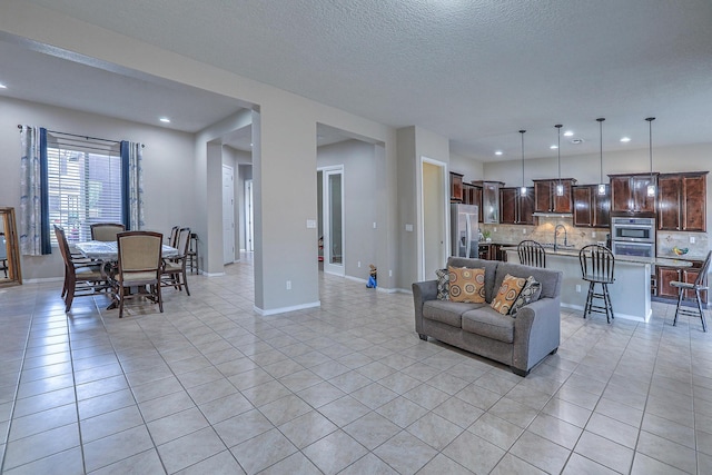 4010 Plaza Colina Ln NE, Rio Rancho, NM 87124 - living area with light tile patterned floors, recessed lighting, baseboards, and a textured ceiling