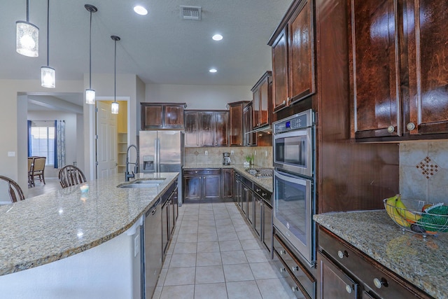 4010 Plaza Colina Ln NE, Rio Rancho, NM 87124 - kitchen featuring tasteful backsplash, light stone counters, a sink, decorative light fixtures, and recessed lighting