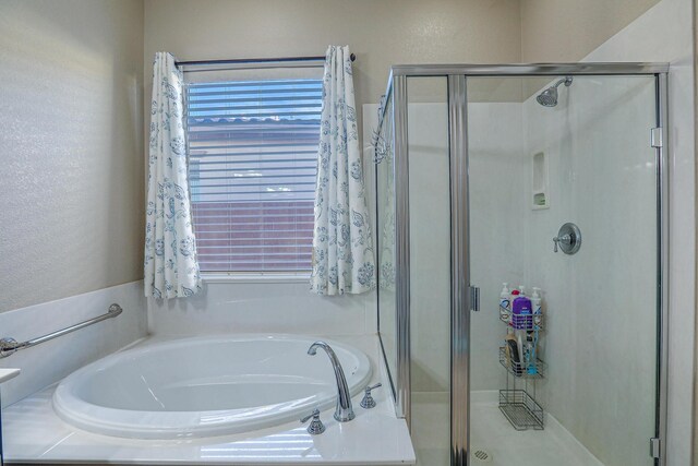full bath featuring a garden tub, a stall shower, and a wealth of natural light