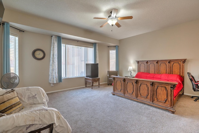 bedroom with a textured ceiling, baseboards, and light carpet
