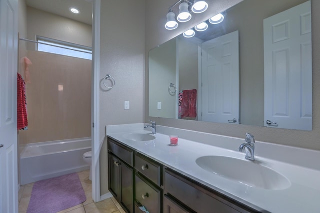 full bath featuring tile patterned floors, toilet, double vanity, and a sink