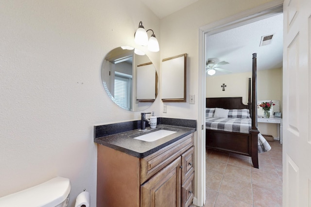 bathroom featuring visible vents, ceiling fan, toilet, tile patterned floors, and vanity