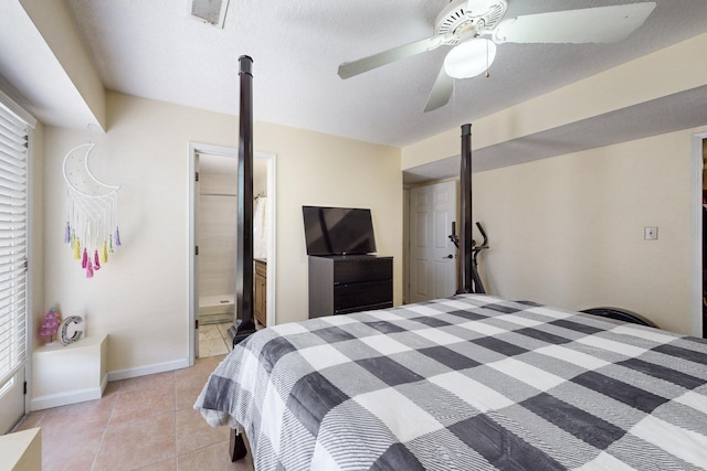 bedroom with visible vents, baseboards, ceiling fan, ensuite bath, and light tile patterned floors