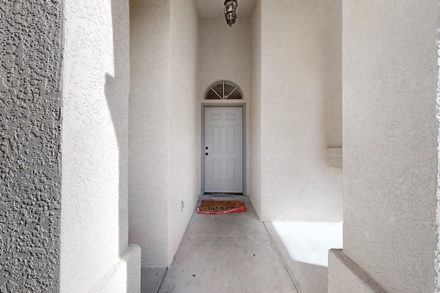doorway to property with stucco siding