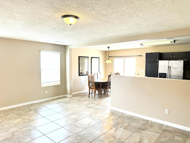 131 Las Ramblas Ave NW, Rio Rancho, NM 87144 - empty room with baseboards, light marble finish floors, and a textured ceiling