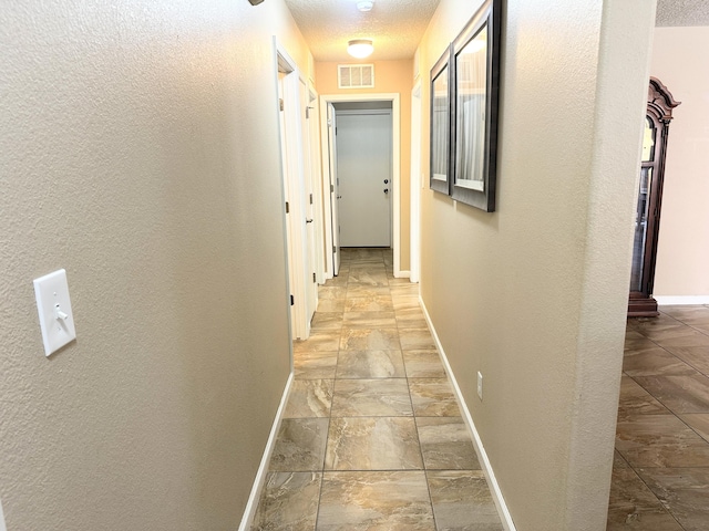 131 Las Ramblas Ave NW, Rio Rancho, NM 87144 - corridor featuring baseboards, a textured wall, and a textured ceiling