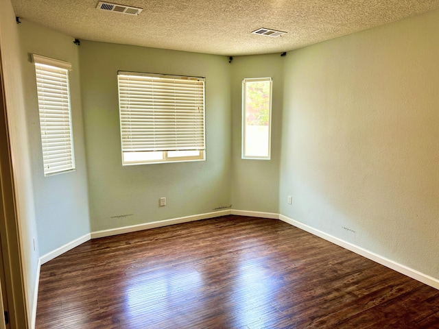 131 Las Ramblas Ave NW, Rio Rancho, NM 87144 - unfurnished room with wood finished floors, a textured ceiling, and baseboards