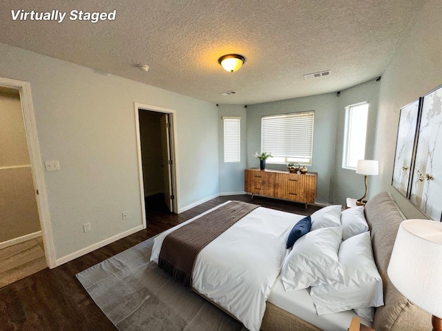 131 Las Ramblas Ave NW, Rio Rancho, NM 87144 - bedroom with wood finished floors, baseboards, and a textured ceiling