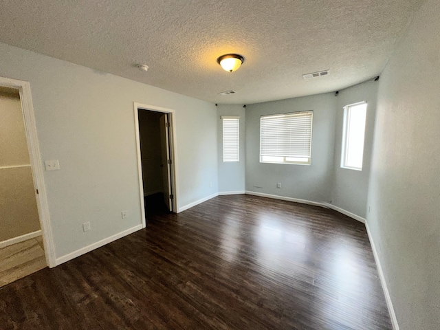 131 Las Ramblas Ave NW, Rio Rancho, NM 87144 - unfurnished bedroom with dark wood finished floors, baseboards, and a textured ceiling