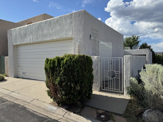 6488 Tahawash St, Cochiti Lake, NM 87083 - garage featuring a gate and fence