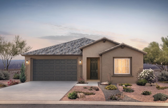 ranch-style house with a garage, concrete driveway, and stucco siding