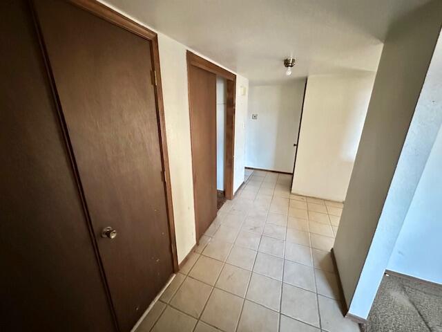 701 Houston Ave, Grants, NM 87020 - hall featuring light tile patterned floors