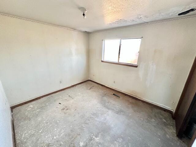 701 Houston Ave, Grants, NM 87020 - unfurnished room featuring unfinished concrete flooring, a textured ceiling, and visible vents