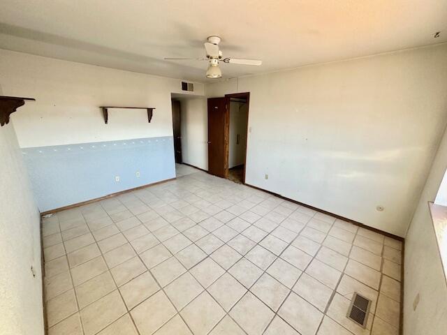 701 Houston Ave, Grants, NM 87020 - empty room with a ceiling fan, baseboards, and visible vents