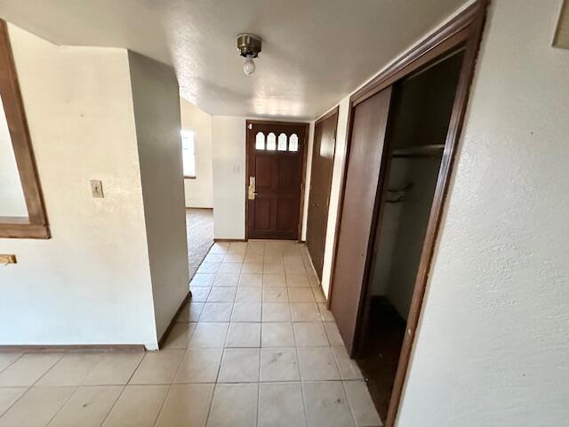 701 Houston Ave, Grants, NM 87020 - corridor featuring baseboards and light tile patterned floors