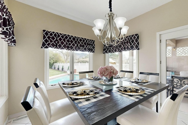 6404 Oak Hill NE, Albuquerque, NM 87111 - dining room with tile patterned floors, baseboards, and an inviting chandelier