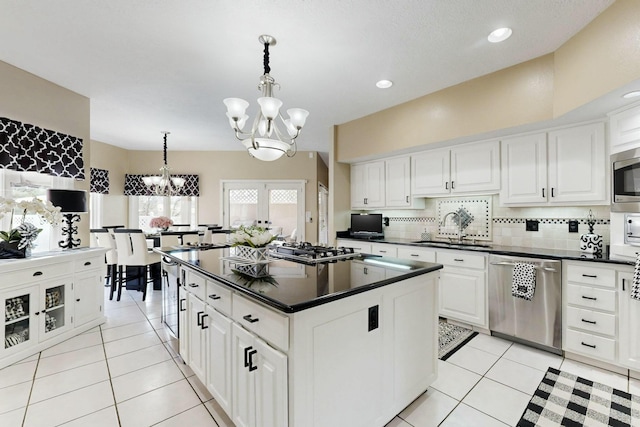 6404 Oak Hill NE, Albuquerque, NM 87111 - kitchen with a notable chandelier, dark countertops, a sink, and stainless steel appliances